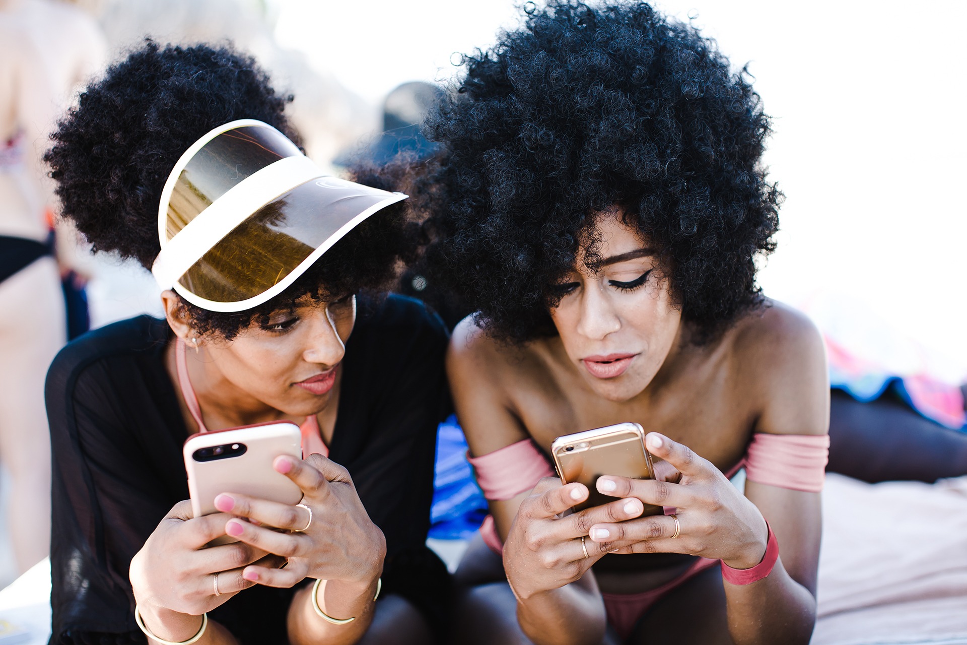 Two woman looking at their phones