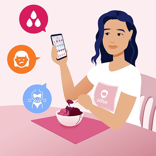 Jasmine eating ice cream and logging her symptoms in the Oohvie app