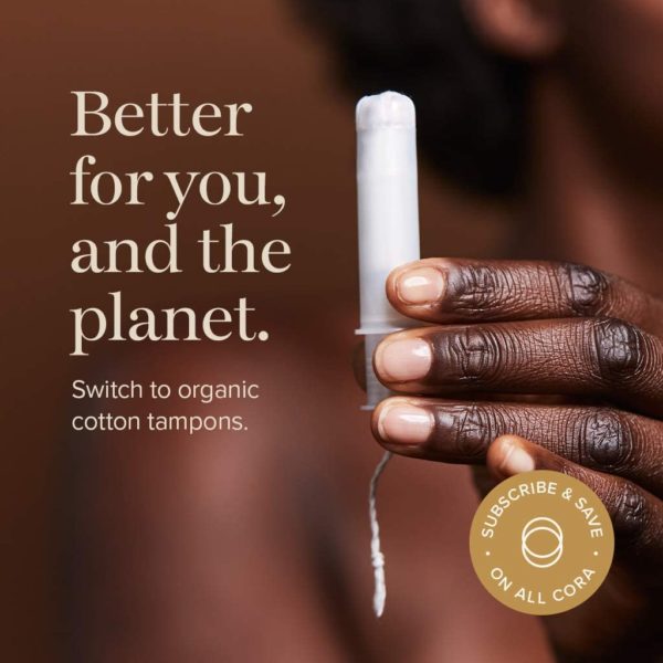 Hand holding Cora organic tampon with applicator